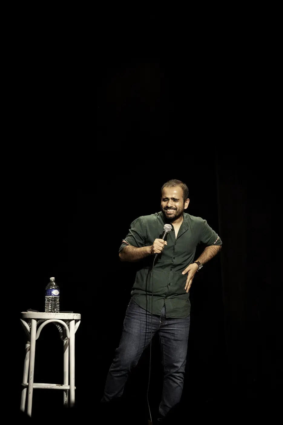 A stand-up comedian alone in the spotlight
